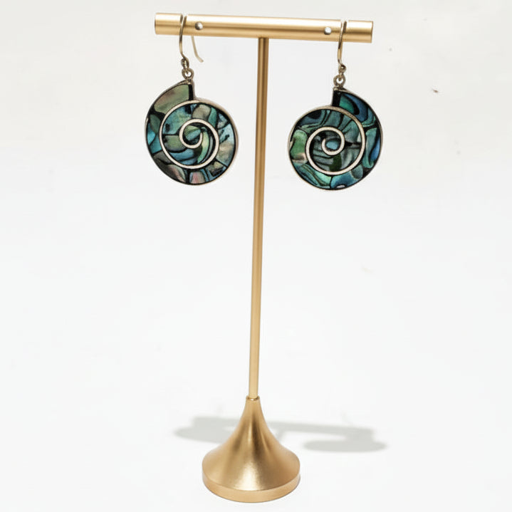 Pair of earrings on a gold stand against a pure white background and keep earring shadow.