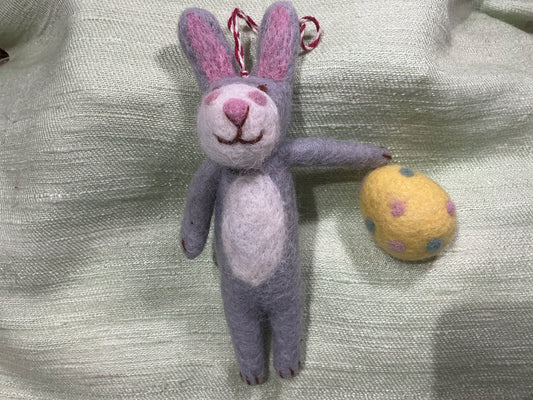 Bunny holding yellow egg wool ornament