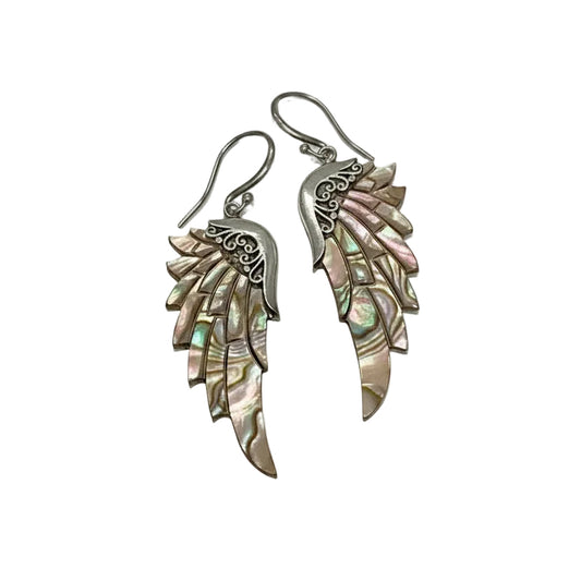 A pair of dangling wing-shaped earrings with iridescent shell-like scales and silver hooks, photographed on a plain light background.